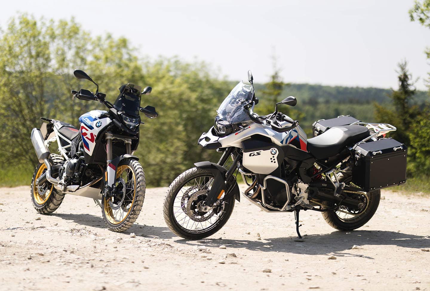 The 2024 BMW F 900 GS and F 900 GS Adventure in LightWhite Racing Blue (GS) and Ride Pro/White Aluminum (Adventure).