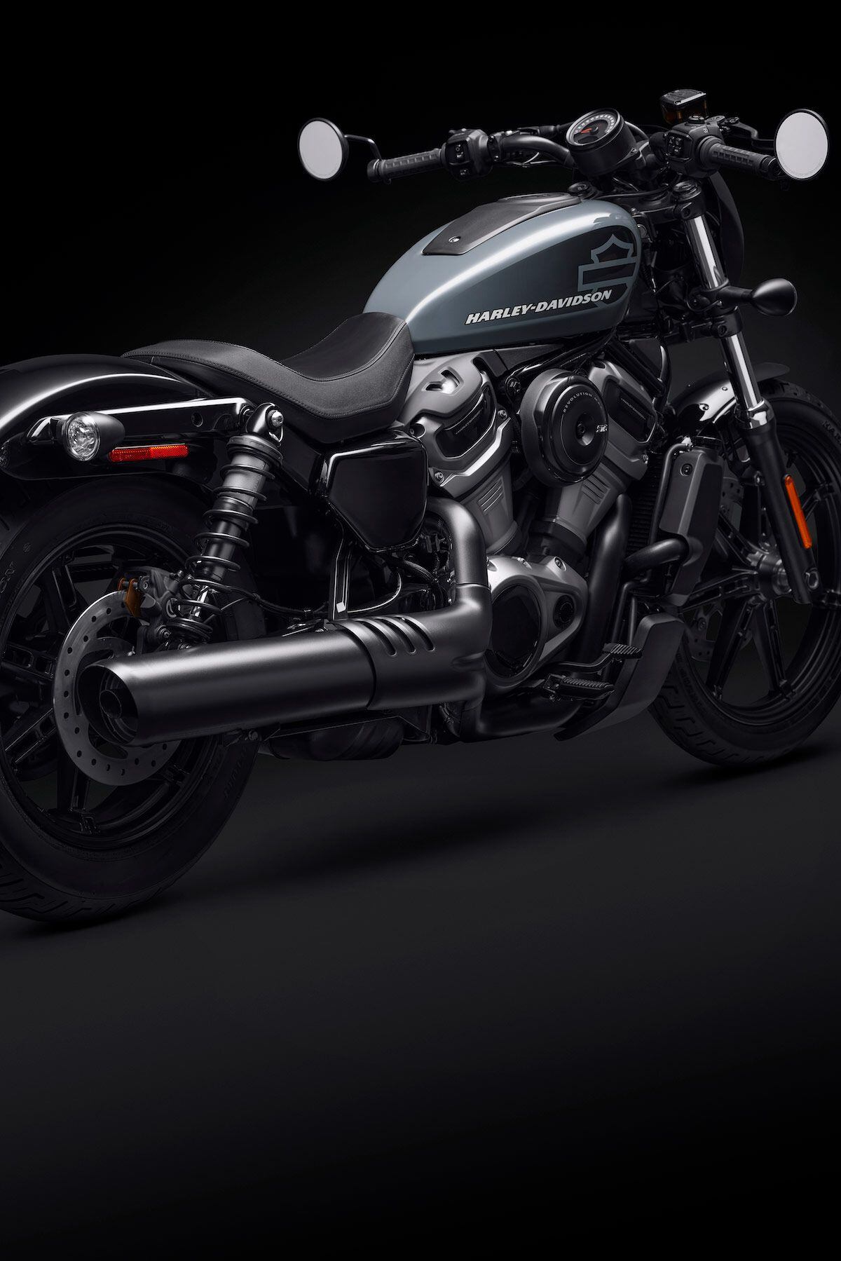 A 2-into-1 exhaust hints at added power; round airbox and airbox “tank” evoke classic Sportster styling.
