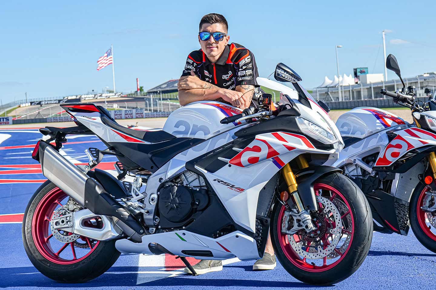 The hardships of being a MotoGP star: Maverick Viñales gets light PR duty behind the Aprilia RSV4 Factory Special Edition.