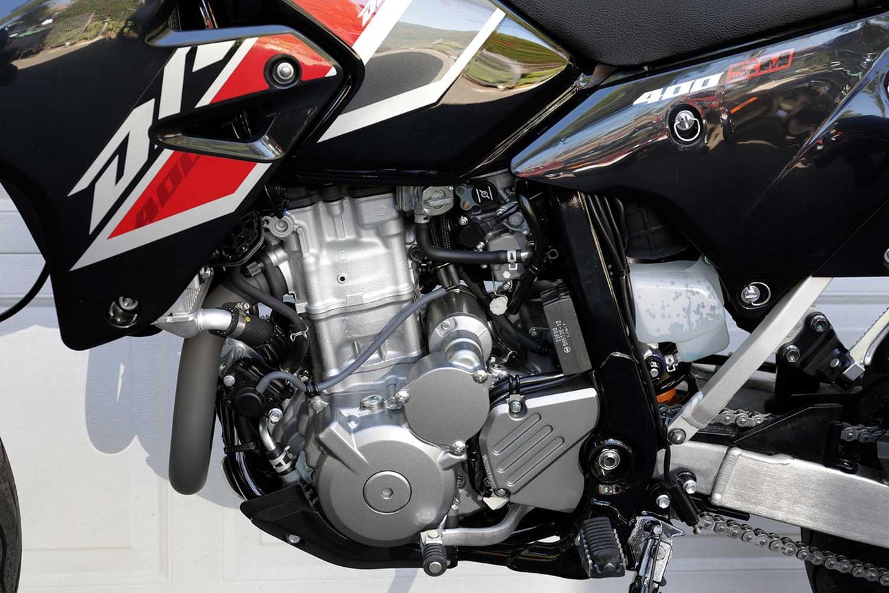 The DR-Z400SM is powered by Suzuki’s tried and true 398cc liquid-cooled single. The engine is good for 32-horsepower at the rear Dunlop.