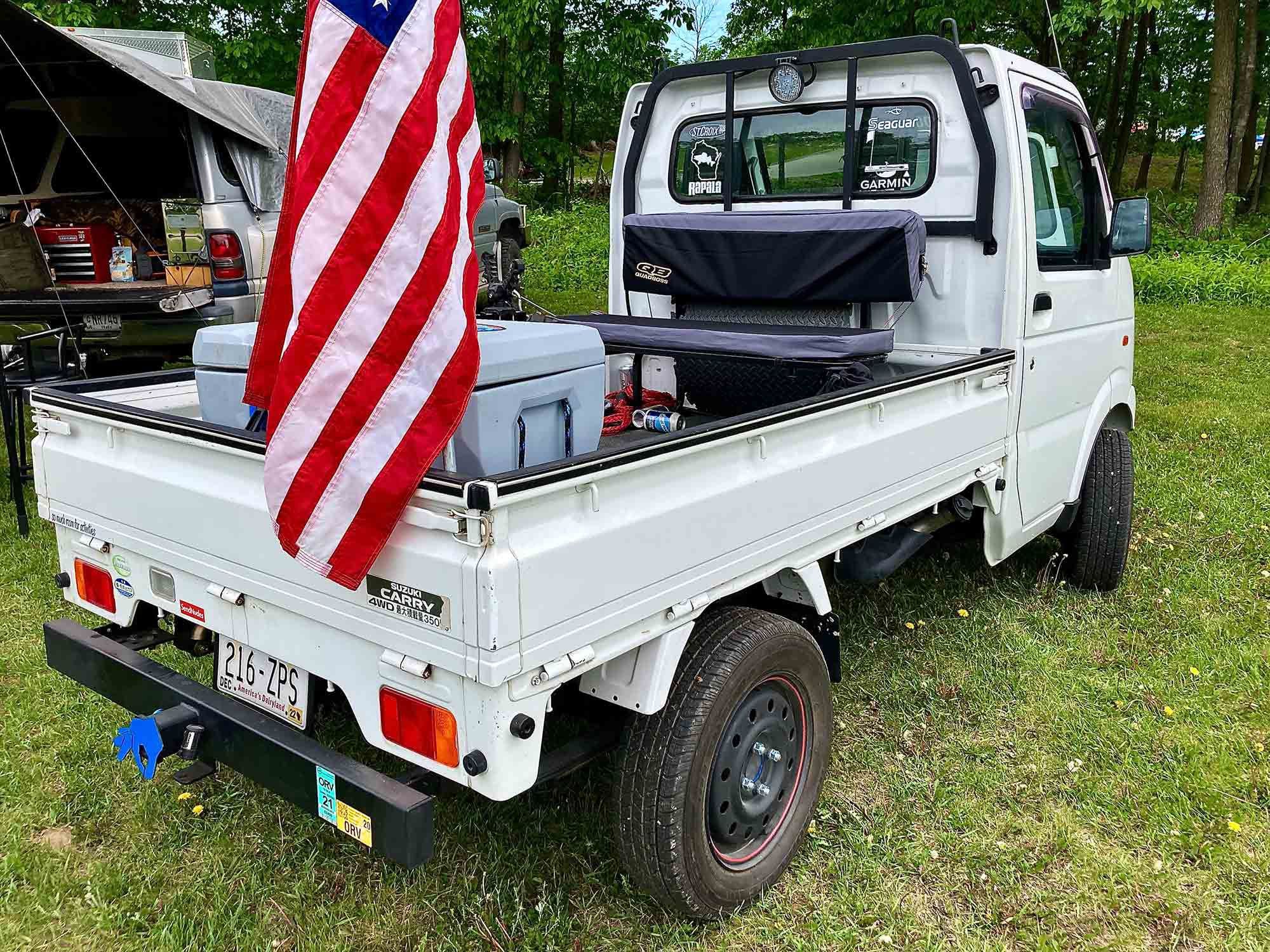 Ready for hauling beer and race fans: a JDM Suzuki Carry 4x4 Kei mini truck.