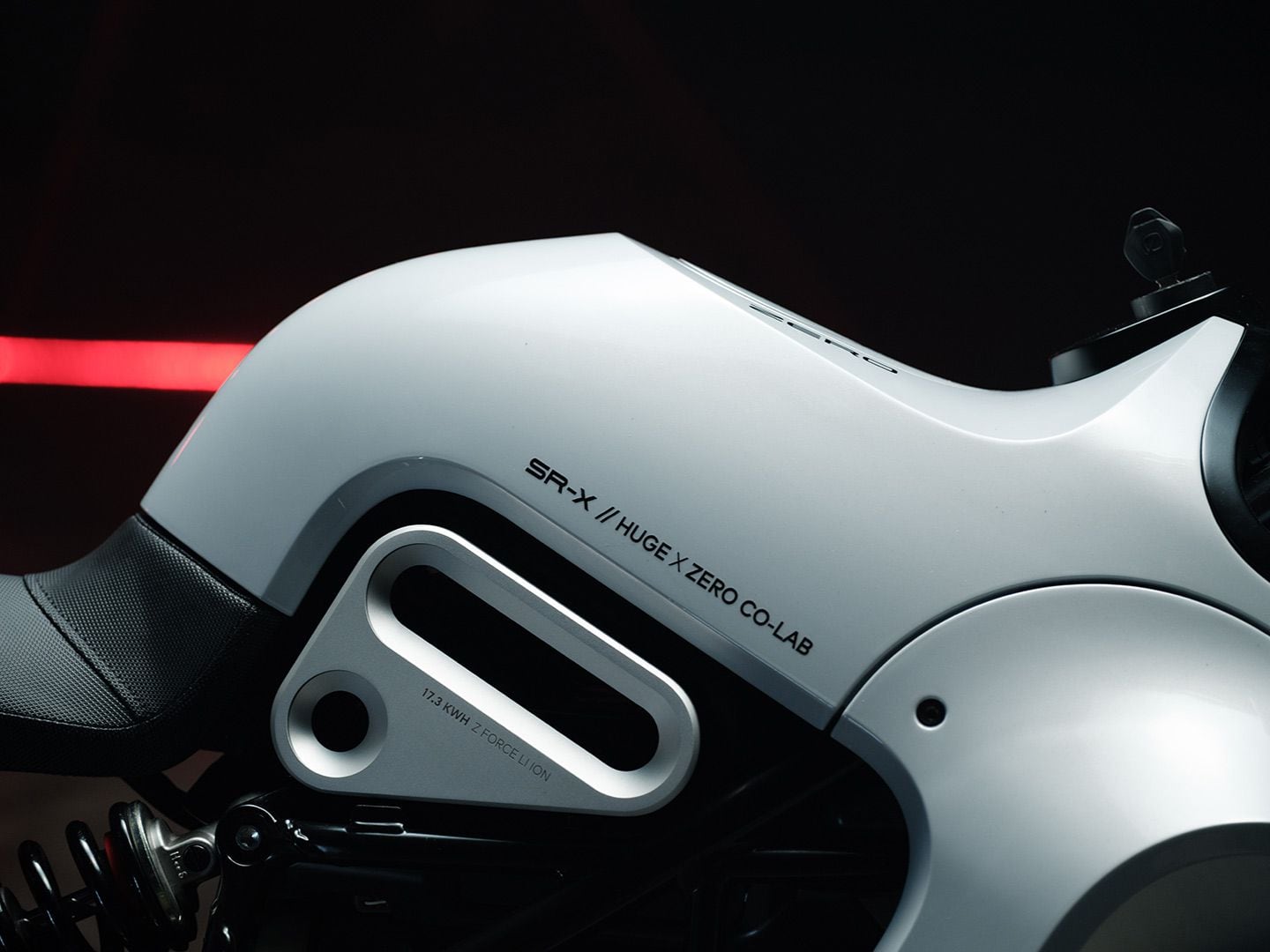 Text on the SR-X’s “fuel tank” section indicates the parties involved in the concept, and below that there’s text calling out what is powering this electric motorcycle.