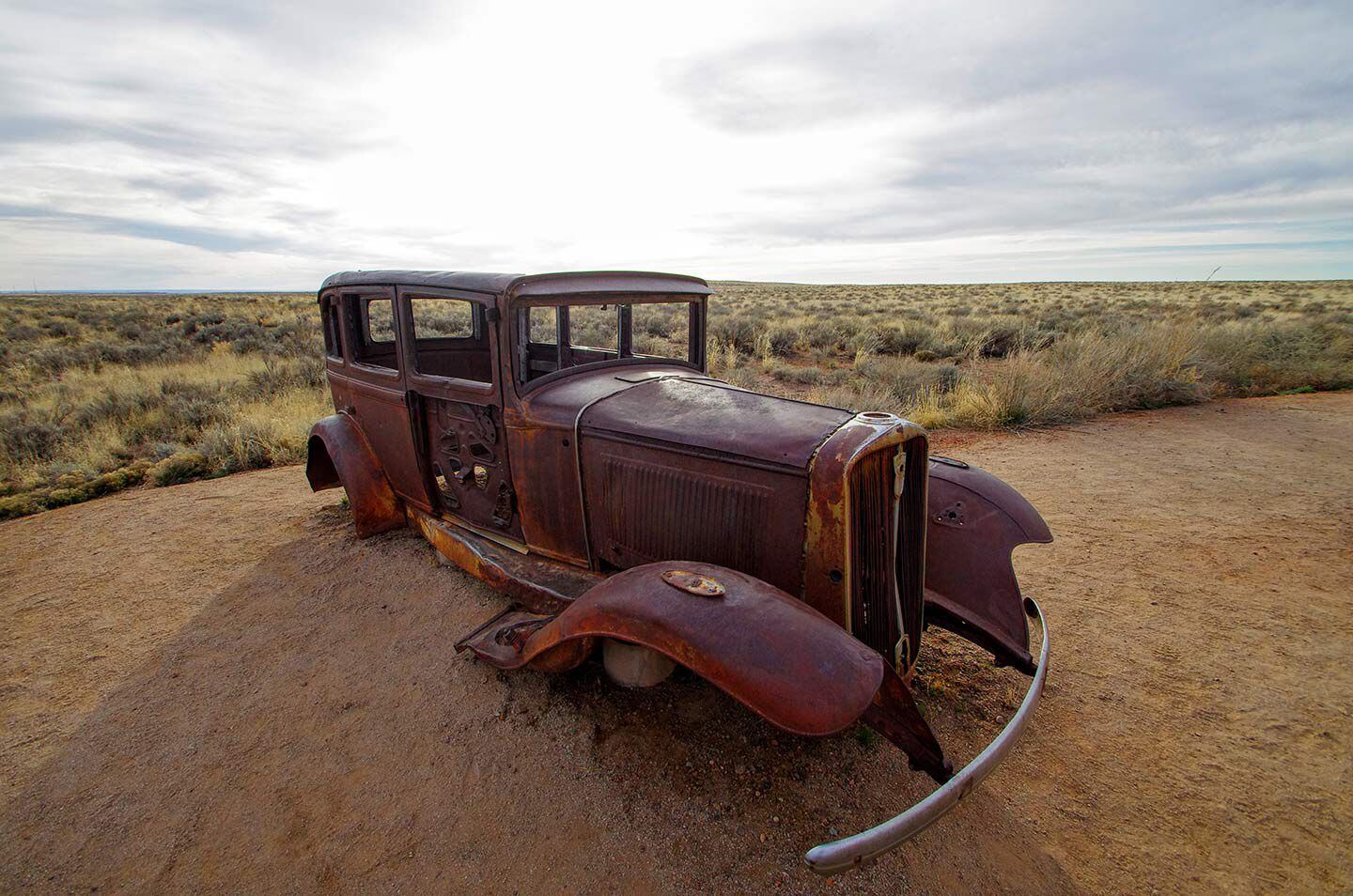 A Studebaker stands sentinel over the site where Route 66 crossed the Petrified Forest N.P. in Arizona.