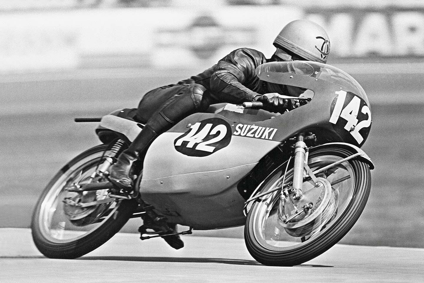 Factory team rider Yoshimi Katayama on a Suzuki RT67 125cc parallel-twin, rotary-valve works racer in the 1967 West German Grand Prix at Hockenheim, which he won.