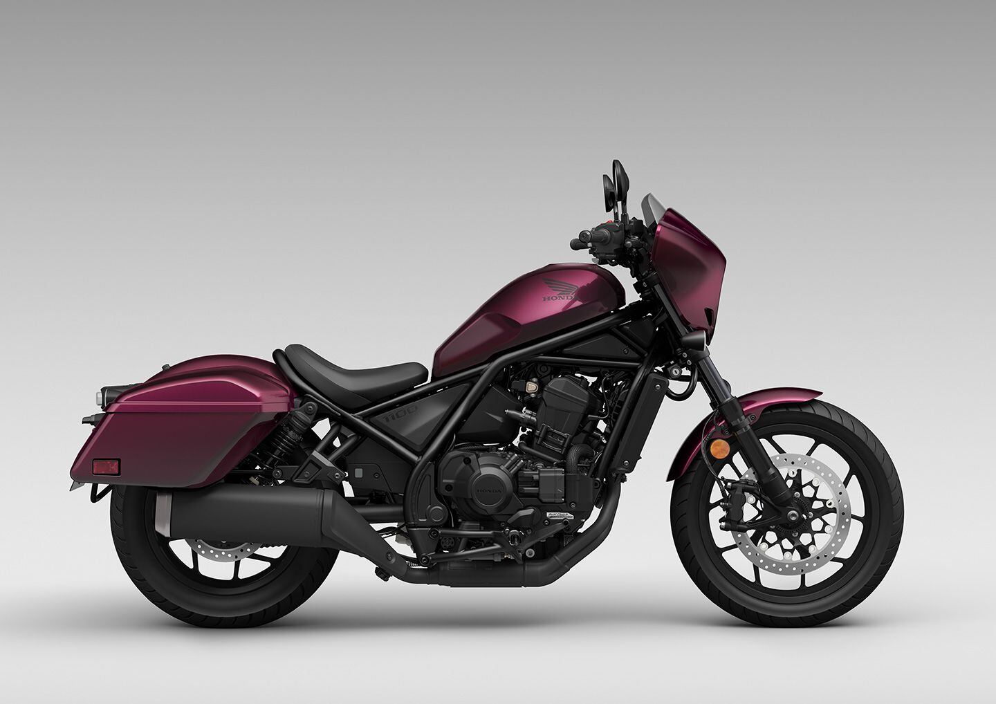The 2023 Rebel 1100T DCT in Bordeaux Red Metallic ($11,299). A windscreen, standard Dual Clutch Transmission (DCT), and hard saddlebags make the 1100T the top of the Rebel food chain.
