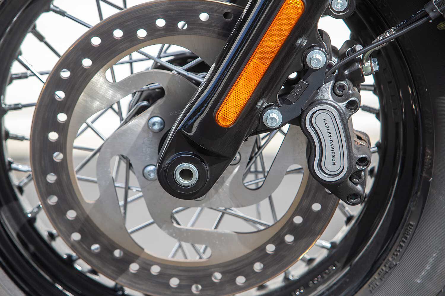 A single four-piston caliper clamping to a large 300mm disc up front helps stop the Softail Slim relatively quickly, but struggles to present feel at the lever.