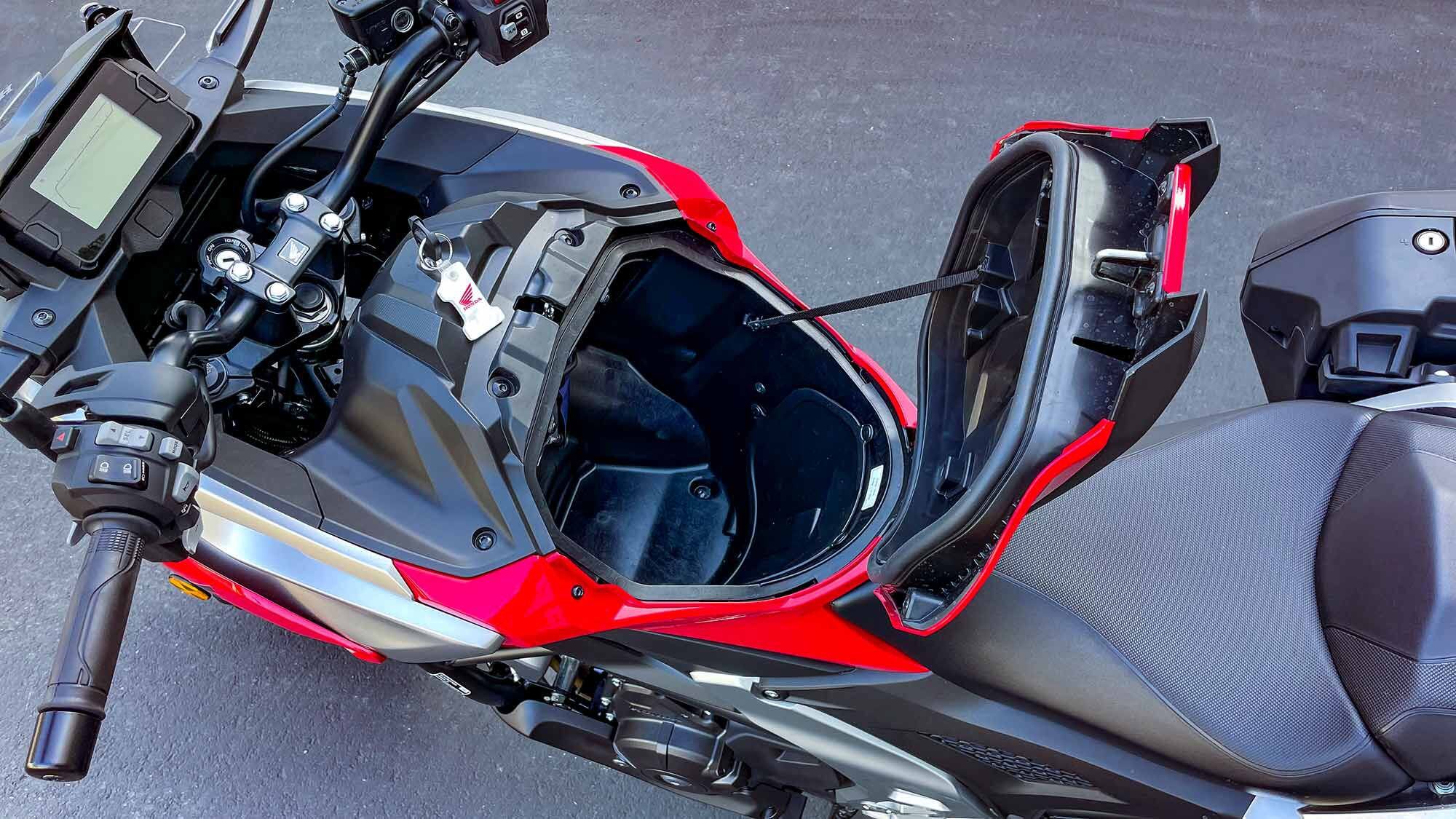 This 28-liter internal storage compartment takes up the traditional location of the fuel tank. Honda claims it will fit most full-face helmets, which we confirmed with an Arai Signet-X.