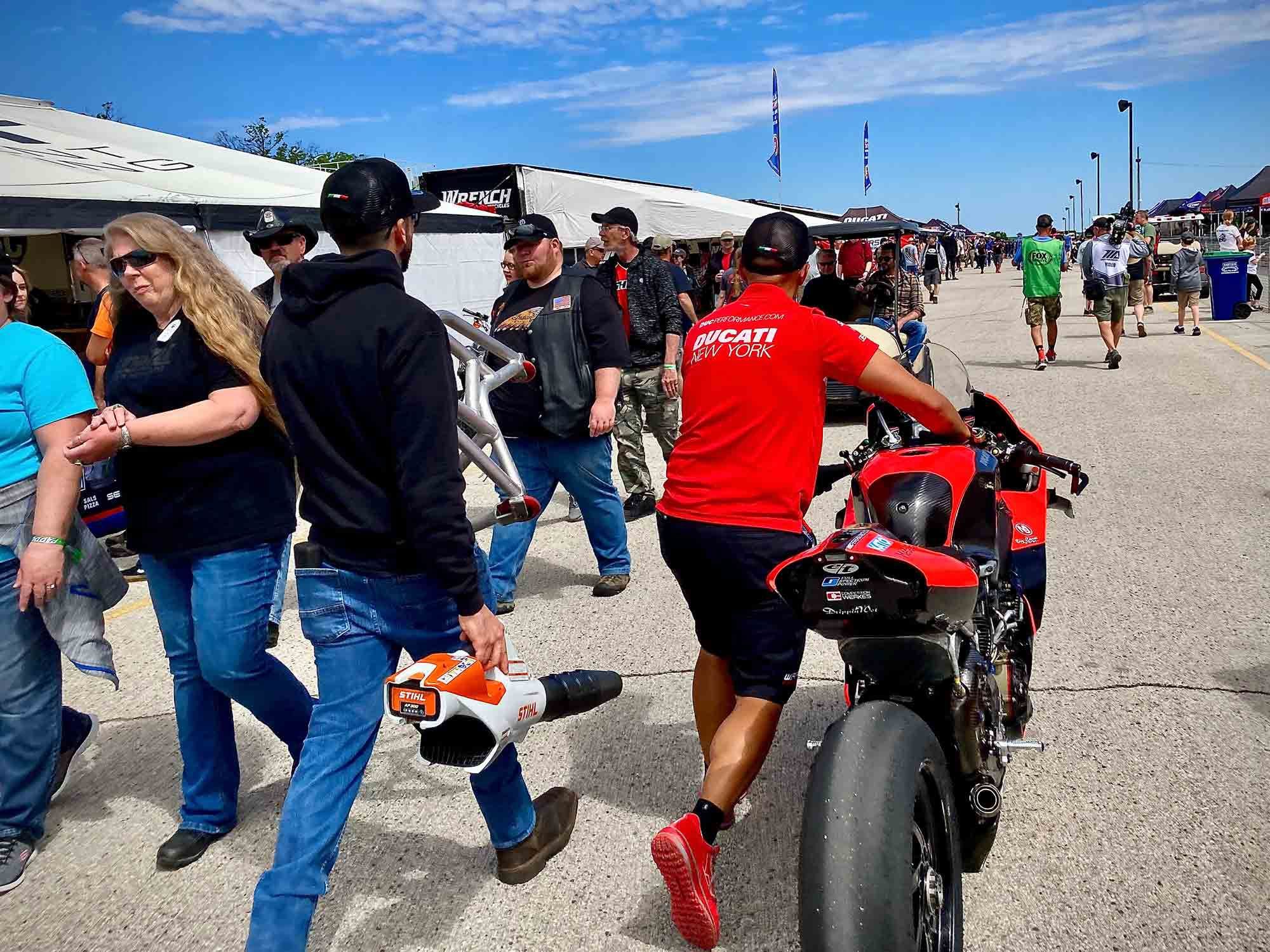 One of the Warhorse HSBK Racing Ducatis is wheeled through the unwashed masses.