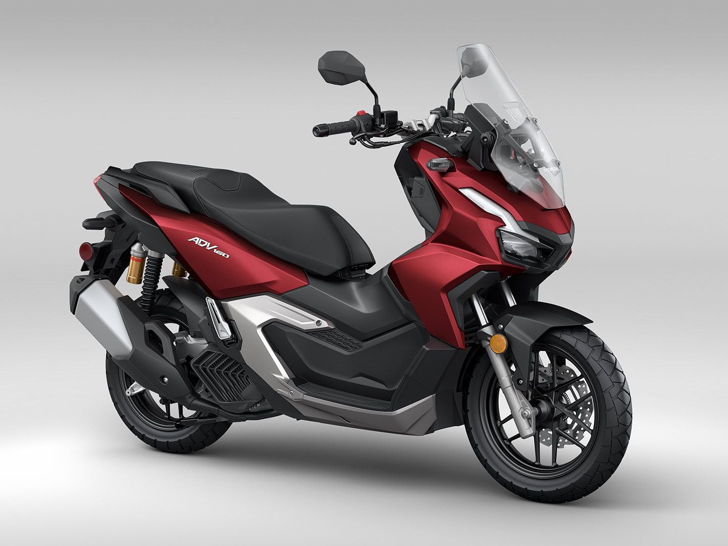 The 2024 Honda ADV160 with Showa shocks and suspension, front and back. Here shown in Red Metallic color.