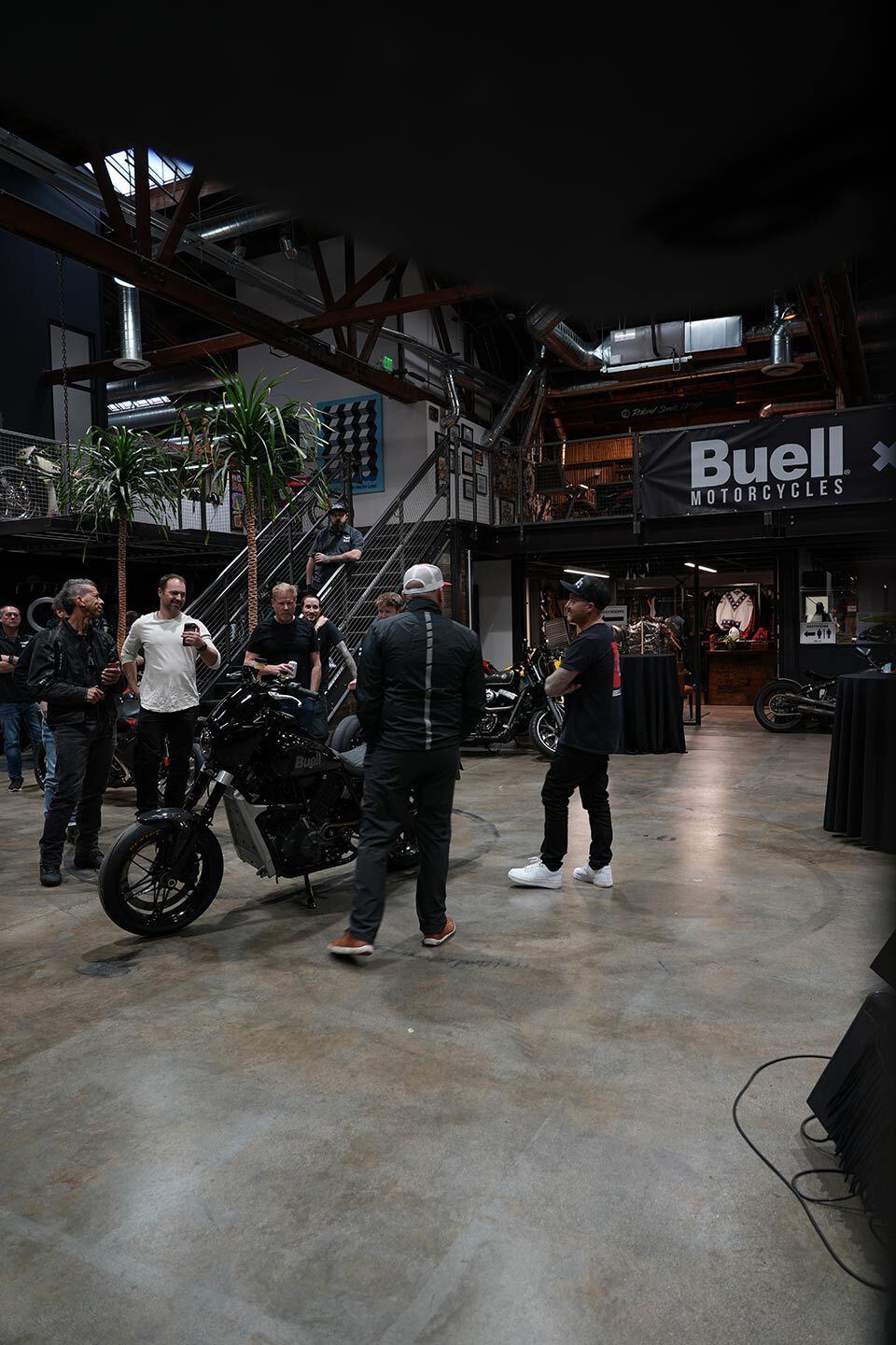 Roland Sands (right) shares the rundown on Buell’s Super Cruiser to classic members of the motorcycle media.