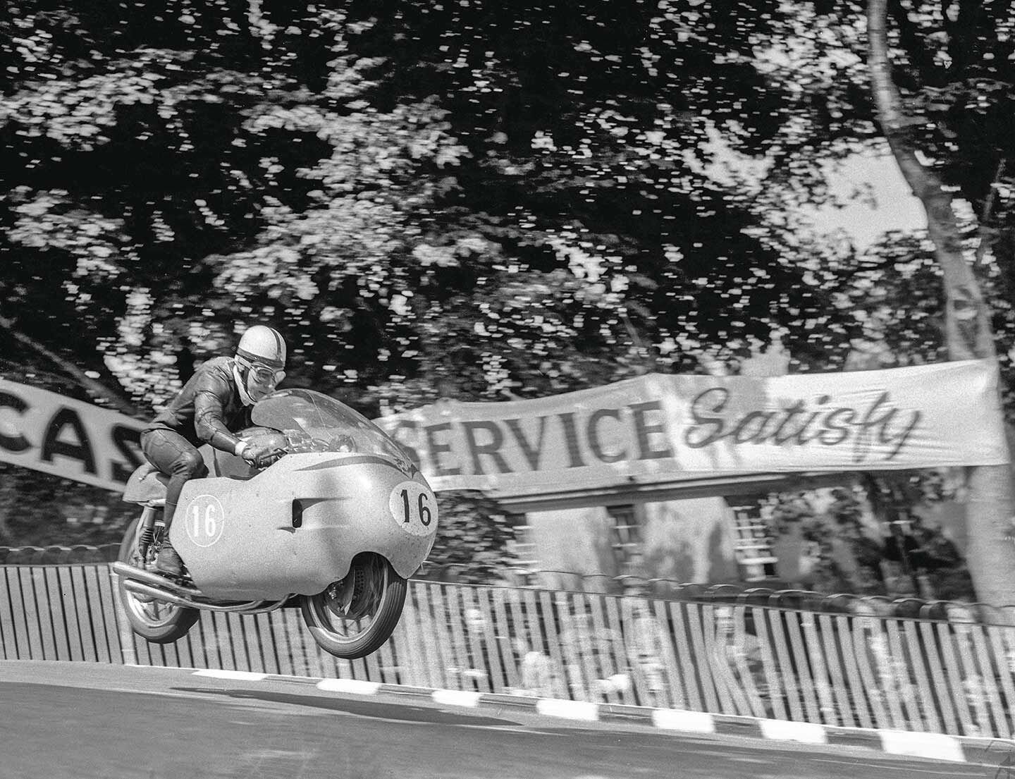 John Surtees flying off Ballaugh Bridge on an MV Agusta 350 4C in the 1957 Isle of Man Junior TT. He took an uncharacteristic fourth place.
