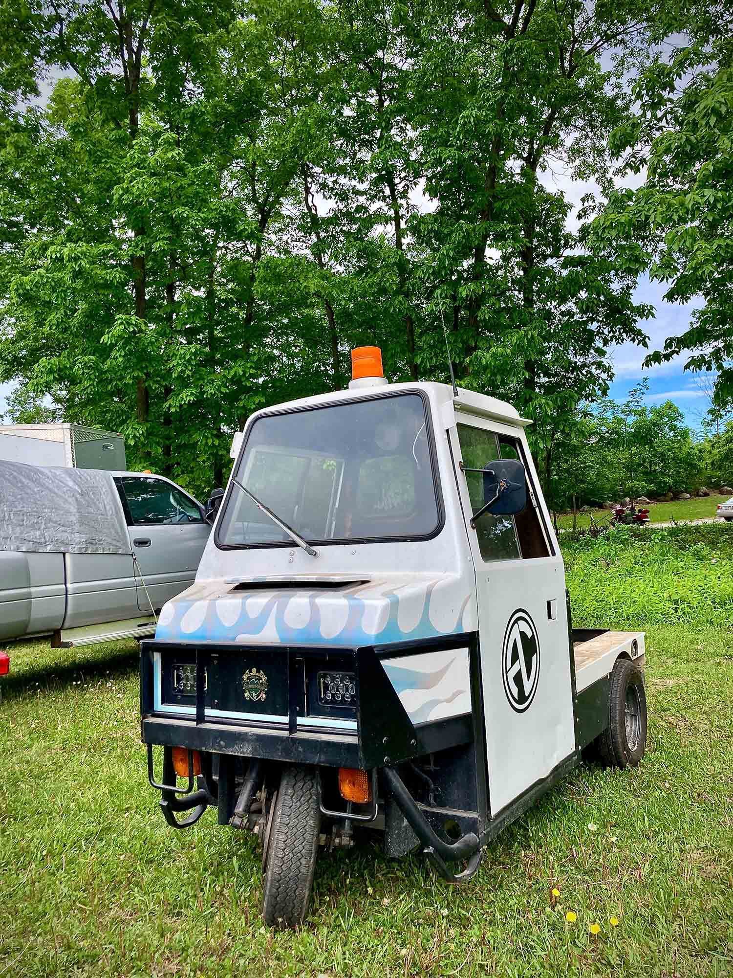 Score at the airport auction: likely a Piaggio Ape.