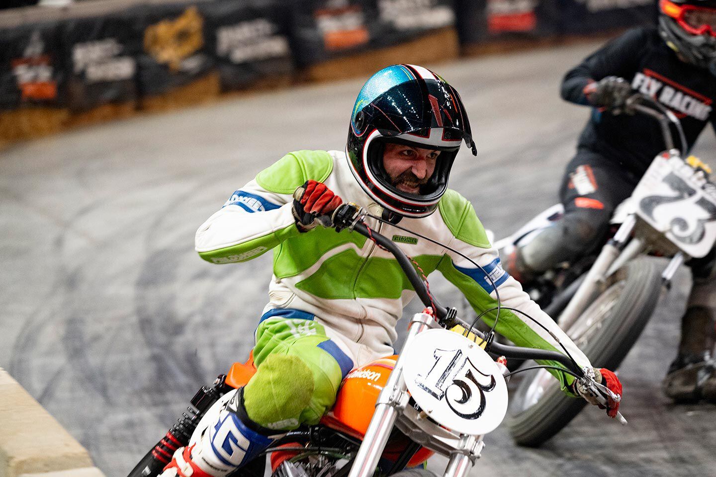Kaleb Zink (15) applies Team Green grit to his orange Harley-Davidson in the Vintage class, Flat Out Friday.