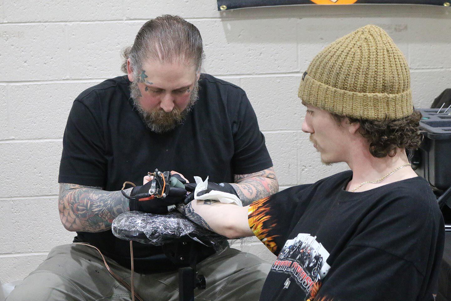 Tattoo artists were busy at the Cherry City Classic because there were lots of riders looking to get new ink.
