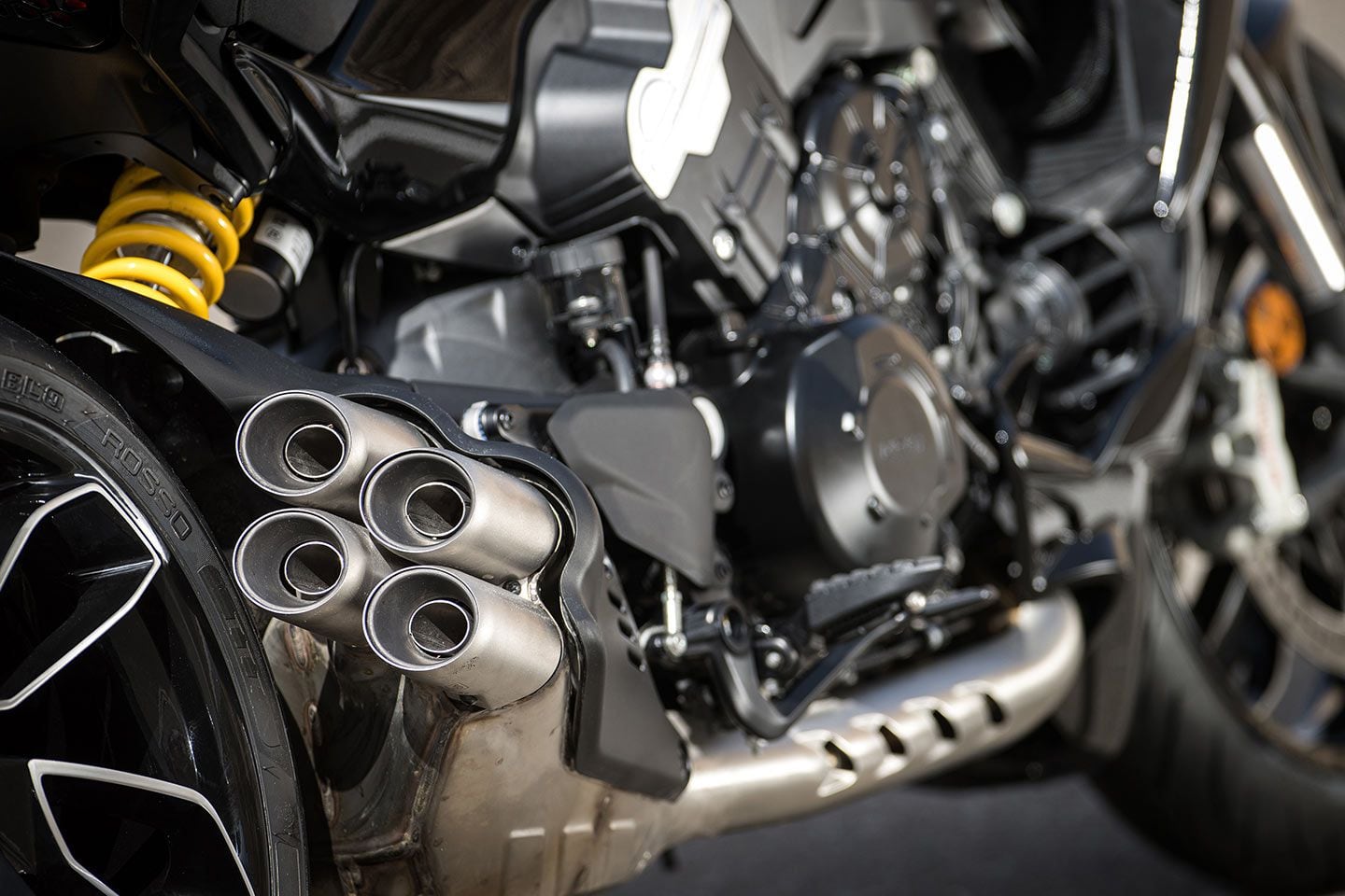 Four clustered exhaust silencers protrude from the main silencer informing you this is a V-4.