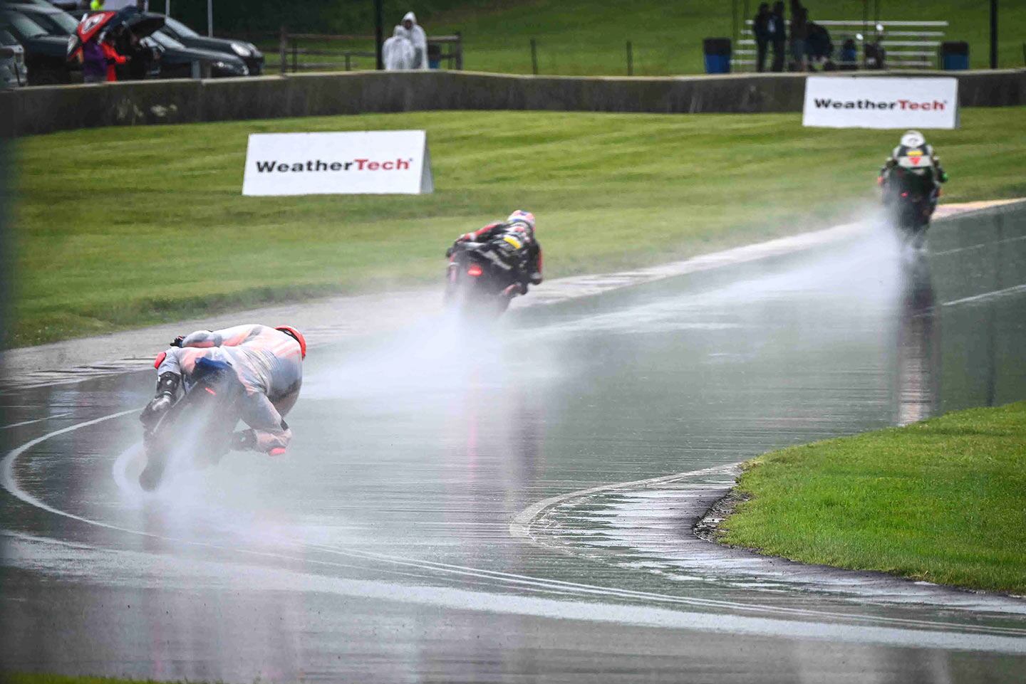 Mind the gap, mind the spray. Riders charge out of turn 14 and head for the tower at Road America.