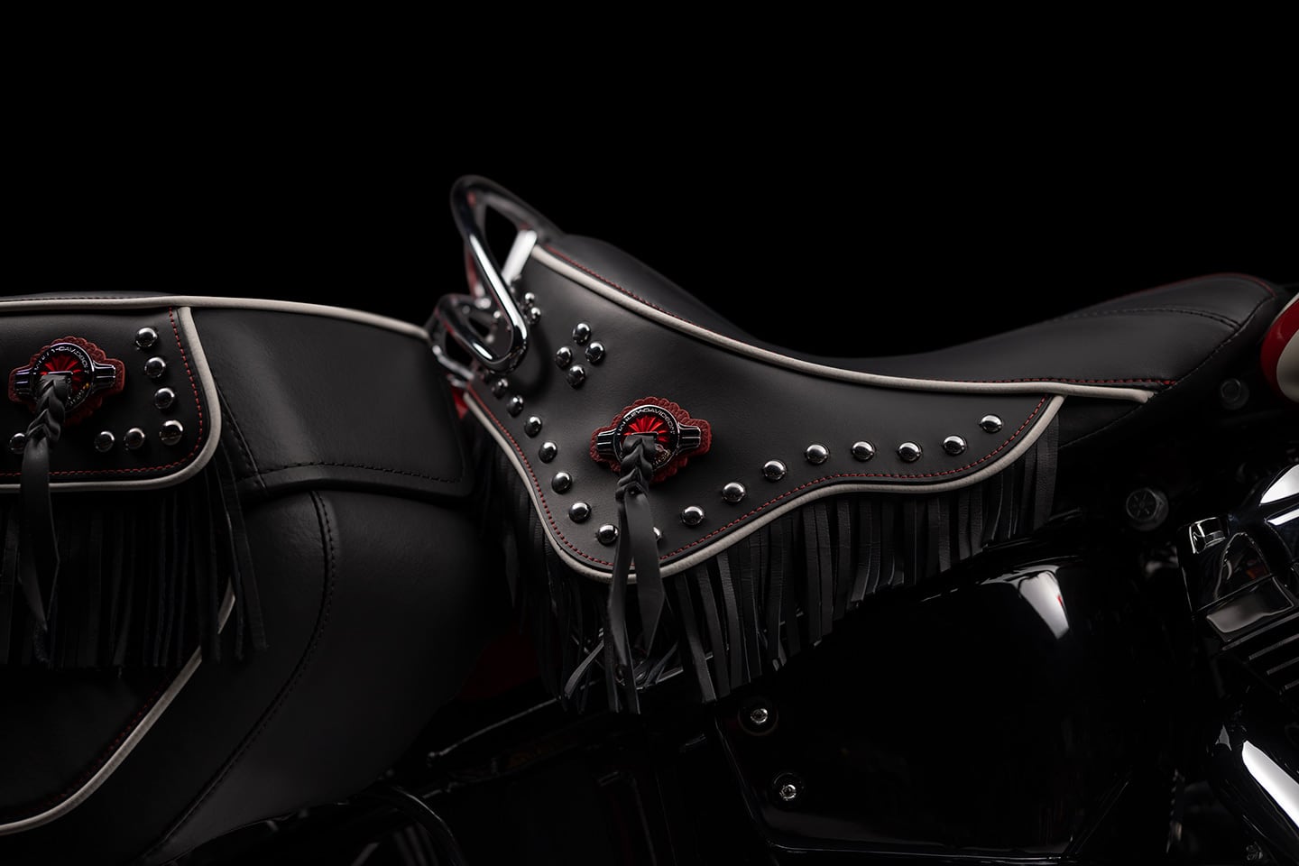 The Hydra-Glide's solo saddle is embellished with fringe, contrast stitching, piping, and 