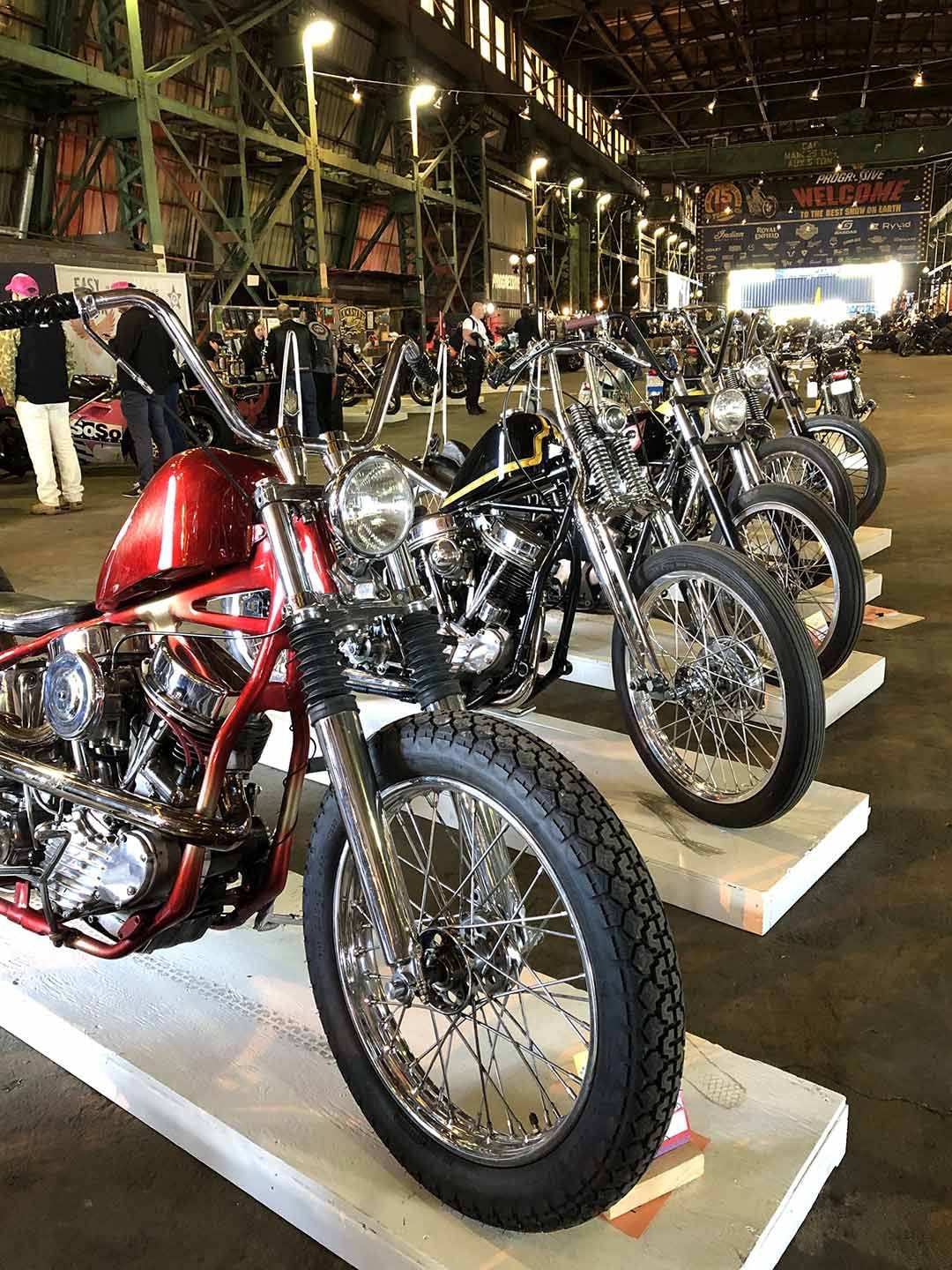 A row of immaculately detailed choppers at the 2024 One Show.